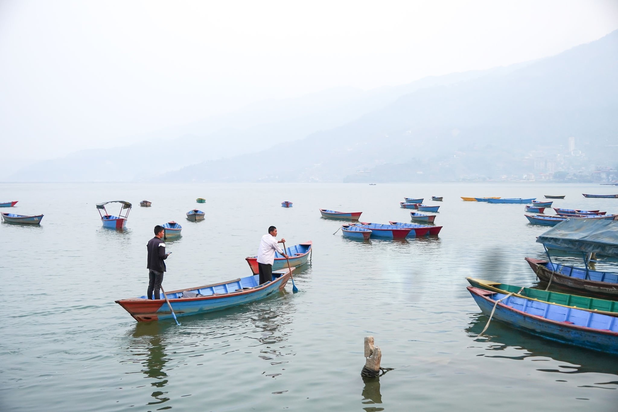 Boat on lake with mountains representing our goals